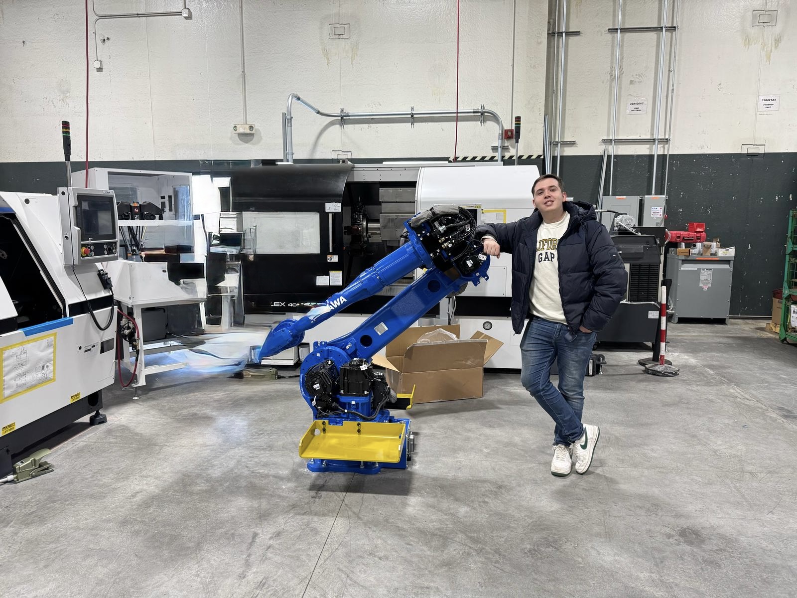 Standing beside an industrial robot cell.